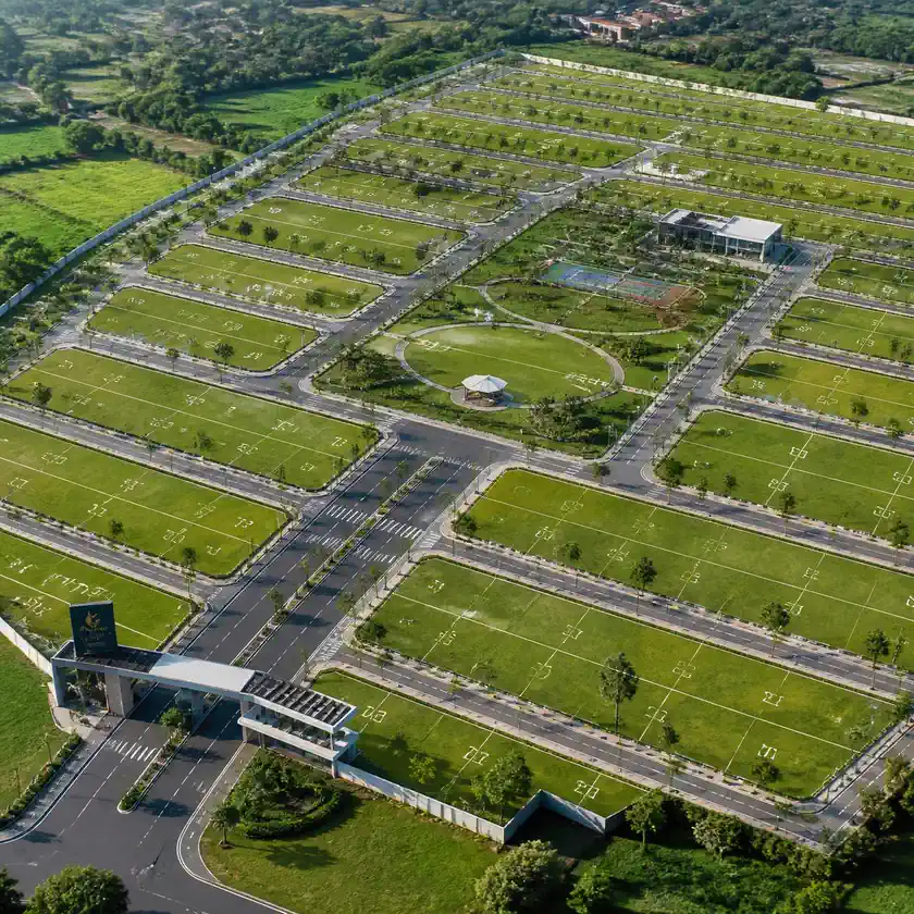 Aerial view of a corner plot with roads and open sides